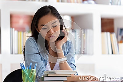 Unmotivated Asian student feel bored unable to study Stock Photo