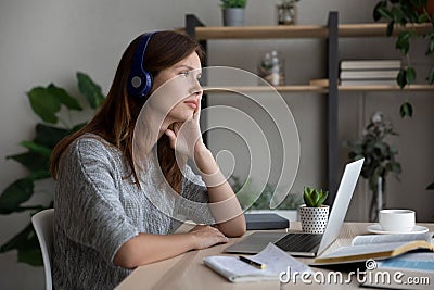 Unmotivated Caucasian woman distracted from studying thinking Stock Photo