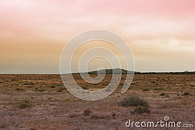 Unnatural arid landscape with weird sky color Stock Photo