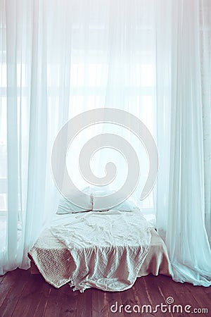 An unoccupied bed against the window. Stock Photo