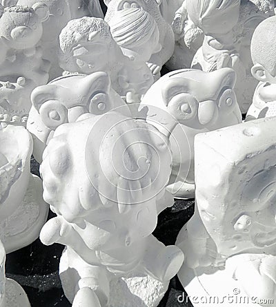 Unpainted white plaster cartoon doll Stock Photo