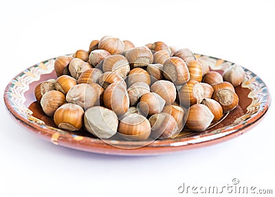 Unpeeled hazelnuts plate Stock Photo