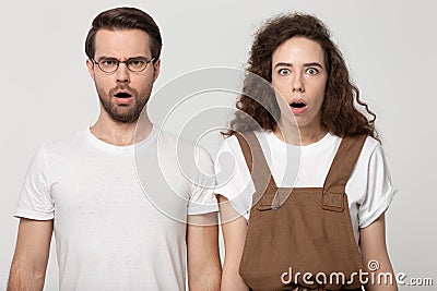 Unpleasantly surprised millennial couple looking at camera. Stock Photo