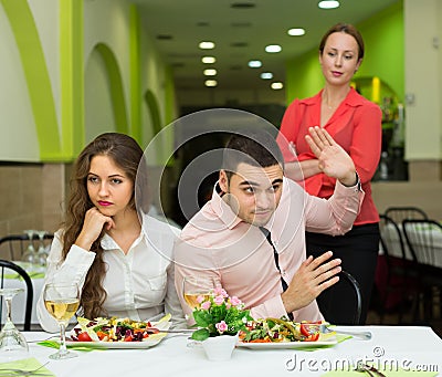 Unpleased couple in restaurant Stock Photo