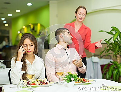 Unpleased couple in restaurant Stock Photo