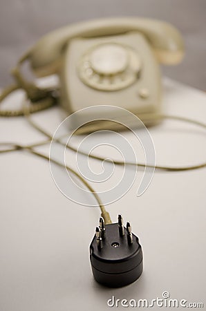 Unplugged analog gray telephone black connecting plug Stock Photo