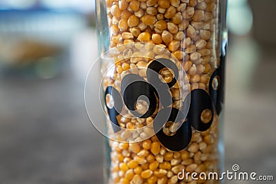 Unpopped Popcorn in vintage 1970s era glass jar. Stock Photo