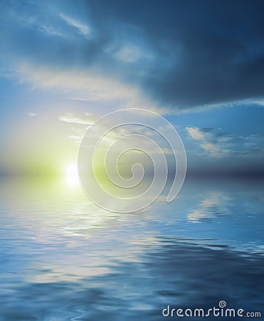 Unreal sunset of blue color reflected in calm sea water Stock Photo