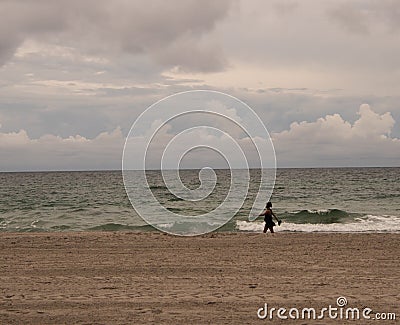 Unrecgonizable Woman walking on beach Stock Photo
