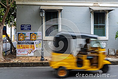 Unrecognisable man in a rickshaw in front of street sign Editorial Stock Photo
