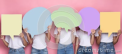 Unrecognizabe Ladies Holding Empty Colorful Speech Bubbles Standing In Studio Stock Photo