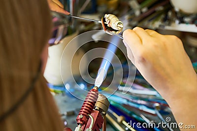Unrecognizable Artist Shaping Glass in Flame Stock Photo
