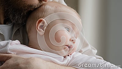 Unrecognizable bearded father daddy caring parent holding caucasian baby kissing child head expressing love paternal Stock Photo