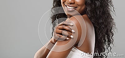 Unrecognizable black woman enjoying her smooth skin over grey background Stock Photo