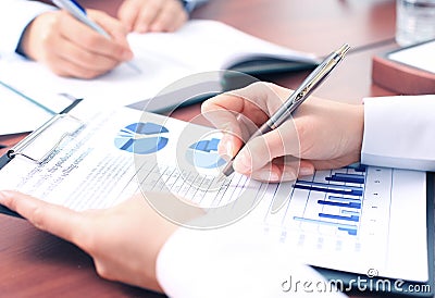 Unrecognizable business person analyzing graphs Stock Photo