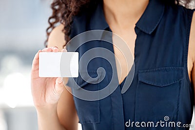 Want to connect. an unrecognizable businessperson showing a business card at work. Stock Photo