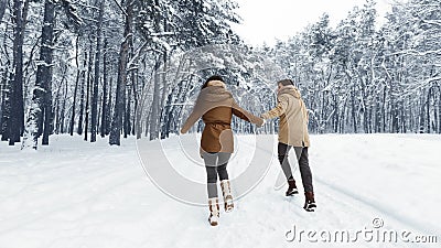 Unrecognizable Couple Running Through Winter Forest Holding Hands, Panorama Stock Photo