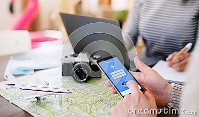 Unrecognizable couple with smartphone planning holiday, coronavirus concept. Stock Photo
