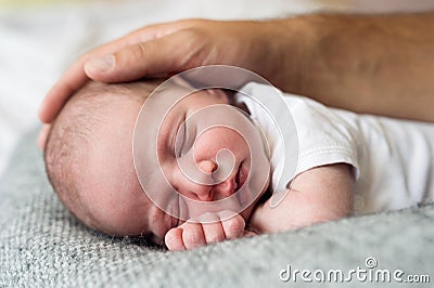 Unrecognizable father caressing his cute little newborn baby boy Stock Photo