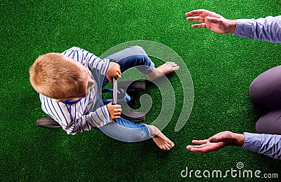 Unrecognizable father catching his son riding a bike Stock Photo