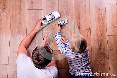 Unrecognizable father with his son playing with cars Stock Photo