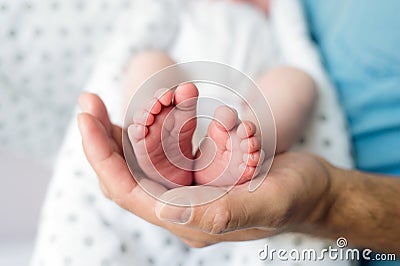 Unrecognizable father with newborn baby son, legs and hand Stock Photo