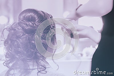 Unrecognizable girl back to us, girl in mirror at hairdresser making hairstyle, styling from long hair, hair salon Stock Photo