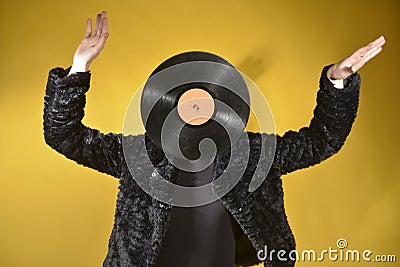 unrecognizable girl face covered with vynil record Stock Photo