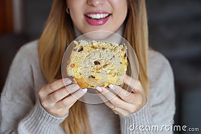 Unrecognizable girl holding a slice of Panettone traditional Christmas cake Stock Photo