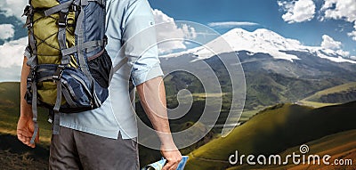 Unrecognizable Male Traveler With A Backpack Looking Into The Distance Mountains, Rear View. Adventure Destination Concept Stock Photo