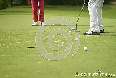 Unrecognizable man playing golf putting on green Stock Photo