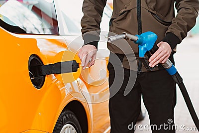 Unrecognizable man refueling car from gas station filling benzine gasoline fuel in car at gas station. Petrol high Stock Photo