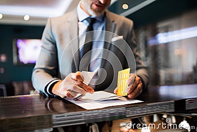 Mature businessman at hotel reception. Stock Photo