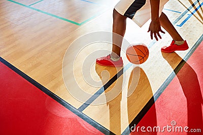 Unrecognizable player dribbling in basketball Stock Photo
