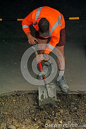 Road worker digging with shovel Stock Photo