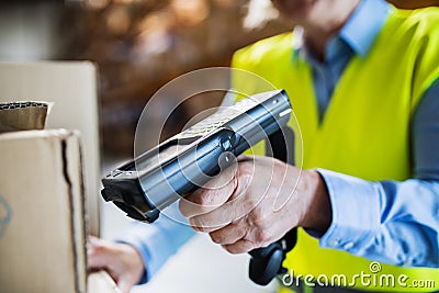 Warehouse woman worker with barcode scanner. Stock Photo