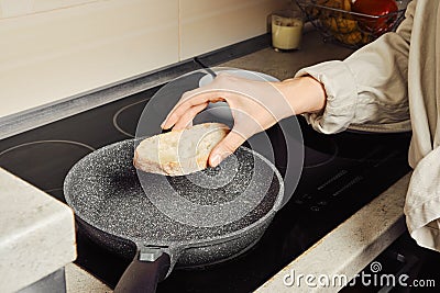 Unrecognizable woman frying bread in a frying pan Stock Photo