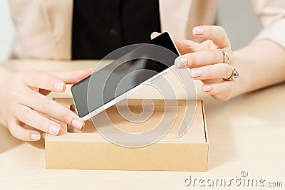 Unrecognizable woman getting new phone out of box Stock Photo