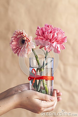 Woman holds up a glass jar of beautiful colorful spring flowers Stock Photo