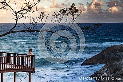 Unrecognizable woman looking at sea from terrace Editorial Stock Photo