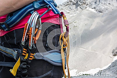 Unrecognizable woman rock climber wearing in safety harness with quickdraws and climbing equipment outdoor. Stock Photo