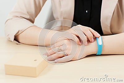 Unrecognizable woman try on blue fitness bracelet Stock Photo