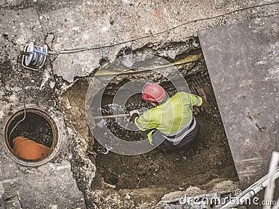 Unrecognizable workers repairing the sewage system Stock Photo