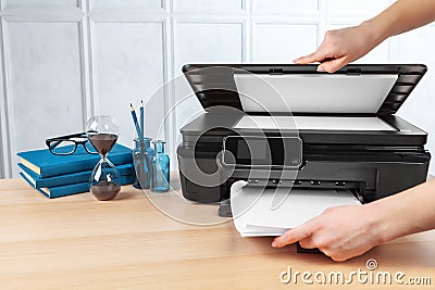 Unrecognizable young businesswoman making copies on the photocopy machine at the office Stock Photo