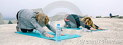 Unrecognizable young and senior woman stretching back outdoors Stock Photo
