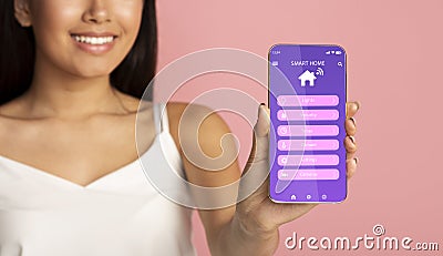 Unrecognizable young woman advertising smarthome mobile app on phone over pink background, collage Stock Photo