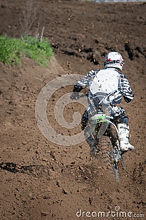 Unrecognized athlete riding a sports motorbike on a motocross racing event. Competitive sport Stock Photo