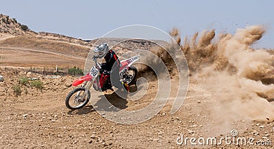 Unrecognized athlete riding a sports motorbike on a motocross racing event. Extreme sports high speed. Editorial Stock Photo