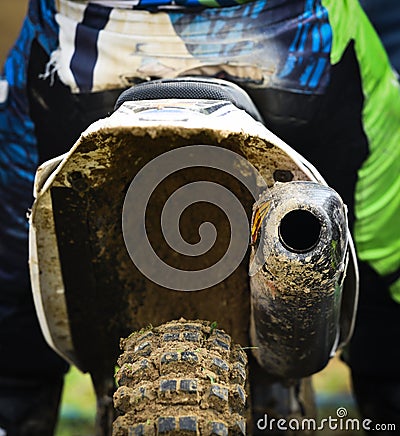 Unrecognized Athlete riding a sports motorbike and muddy wheel Stock Photo