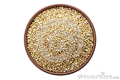 Unroasted buckwheat in a bowl. Isolated on a white background Stock Photo